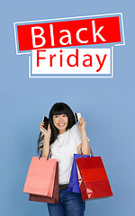 Image showing Beautiful woman inviting for shopping in black friday, sales concept. Vertical flyer, blue background