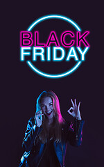 Image showing Beautiful woman inviting for shopping in black friday, sales concept. Vertical flyer, neoned style, dark background