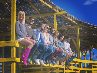 Image showing Group of friends having fun on autumn day at beach