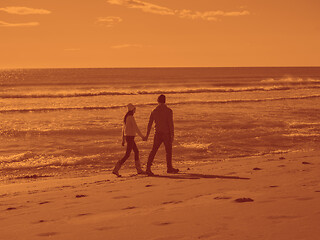 Image showing Loving young couple on a beach at autumn sunny day