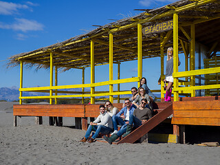 Image showing Group of friends having fun on autumn day at beach