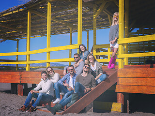 Image showing Group of friends having fun on autumn day at beach