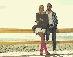 Image showing young couple drinking beer together at the beach