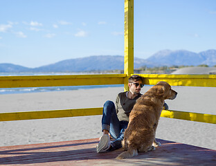 Image showing man with dog enjoying free time on the beach