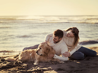 Image showing Couple with dog enjoying time on beach