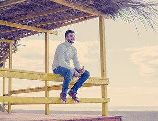 Image showing man drinking beer at the beach