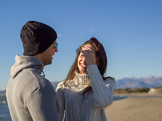 Image showing Loving young couple on a beach at autumn sunny day