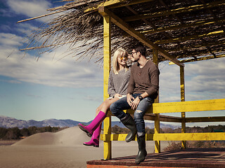 Image showing young couple drinking beer together at the beach