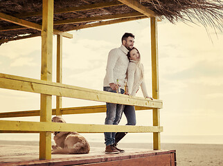 Image showing young couple drinking beer together at the beach