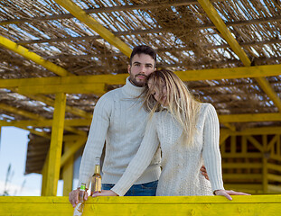 Image showing young couple drinking beer together at the beach