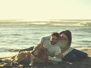 Image showing Couple with dog enjoying time on beach