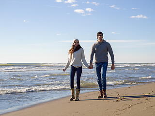 Image showing Loving young couple on a beach at autumn sunny day