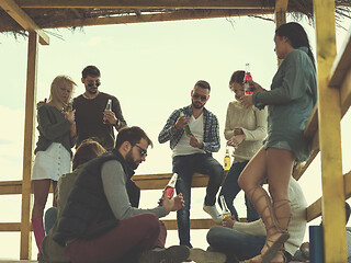 Image showing Group of friends having fun on autumn day at beach