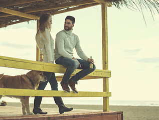 Image showing young couple drinking beer together at the beach