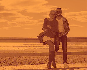 Image showing young couple drinking beer together at the beach