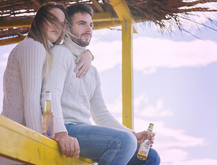 Image showing young couple drinking beer together at the beach