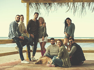 Image showing Group of friends having fun on autumn day at beach