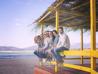 Image showing Group of friends having fun on autumn day at beach