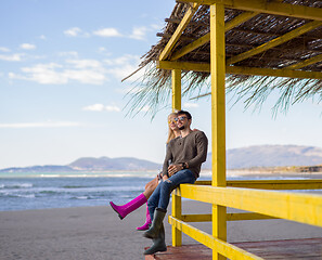 Image showing young couple drinking beer together at the beach