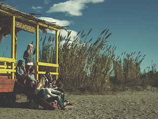 Image showing Group of friends having fun on autumn day at beach