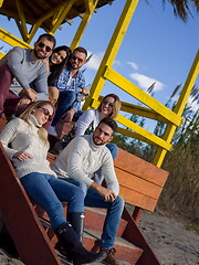 Image showing Group of friends having fun on autumn day at beach