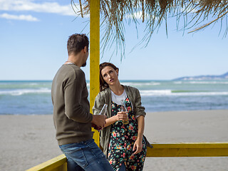 Image showing young couple drinking beer together at the beach