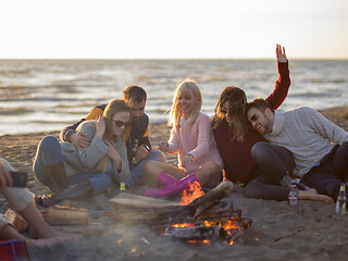 Image showing Friends having fun at beach on autumn day