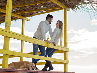 Image showing young couple drinking beer together at the beach