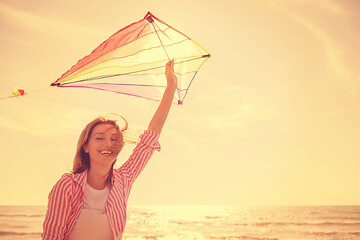 Image showing Young Woman with kite at beach on autumn day