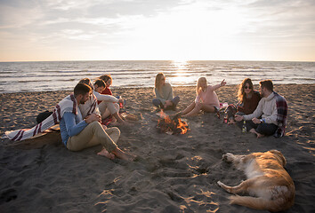 Image showing Friends having fun at beach on autumn day