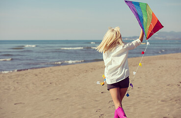 Image showing Young Woman with kite at beach on autumn day