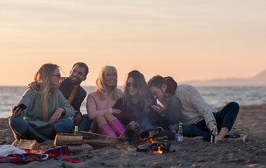 Image showing Friends having fun at beach on autumn day