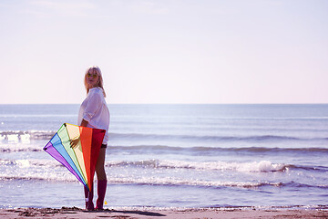 Image showing Young Woman with kite at beach on autumn day