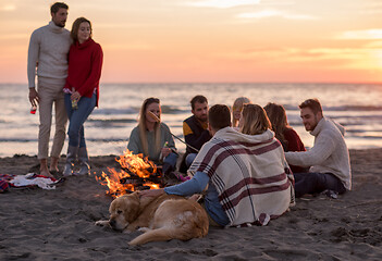 Image showing Friends having fun at beach on autumn day