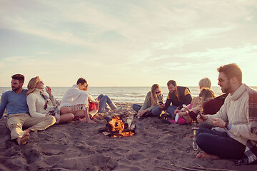 Image showing Friends having fun at beach on autumn day