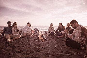 Image showing Friends having fun at beach on autumn day