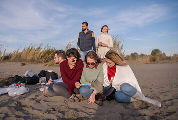 Image showing Friends having fun at beach on autumn day