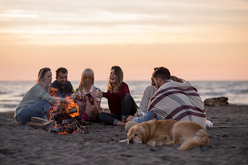 Image showing Friends having fun at beach on autumn day