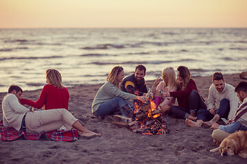 Image showing Friends having fun at beach on autumn day