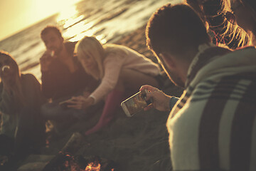 Image showing Friends having fun at beach on autumn day