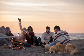 Image showing Friends having fun at beach on autumn day