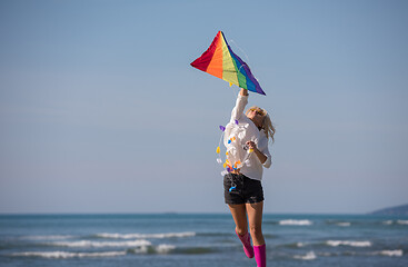 Image showing Young Woman with kite at beach on autumn day