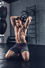 Image showing The athlete trains hard in the gym. Fitness and healthy life concept.