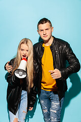 Image showing Portrait of young emotional female student with megaphone