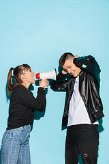 Image showing Portrait of young emotional female student with megaphone