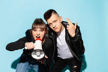 Image showing Portrait of young emotional female student with megaphone