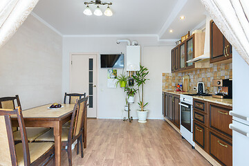 Image showing Interior of a spacious living room and kitchen with a classic wood grain design