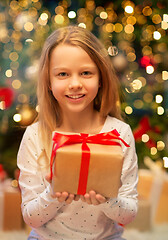 Image showing smiling girl with christmas gift at home