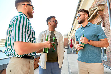 Image showing happy male friends drinking beer at rooftop party