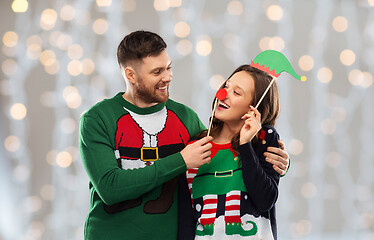 Image showing couple with christmas party props in ugly sweaters